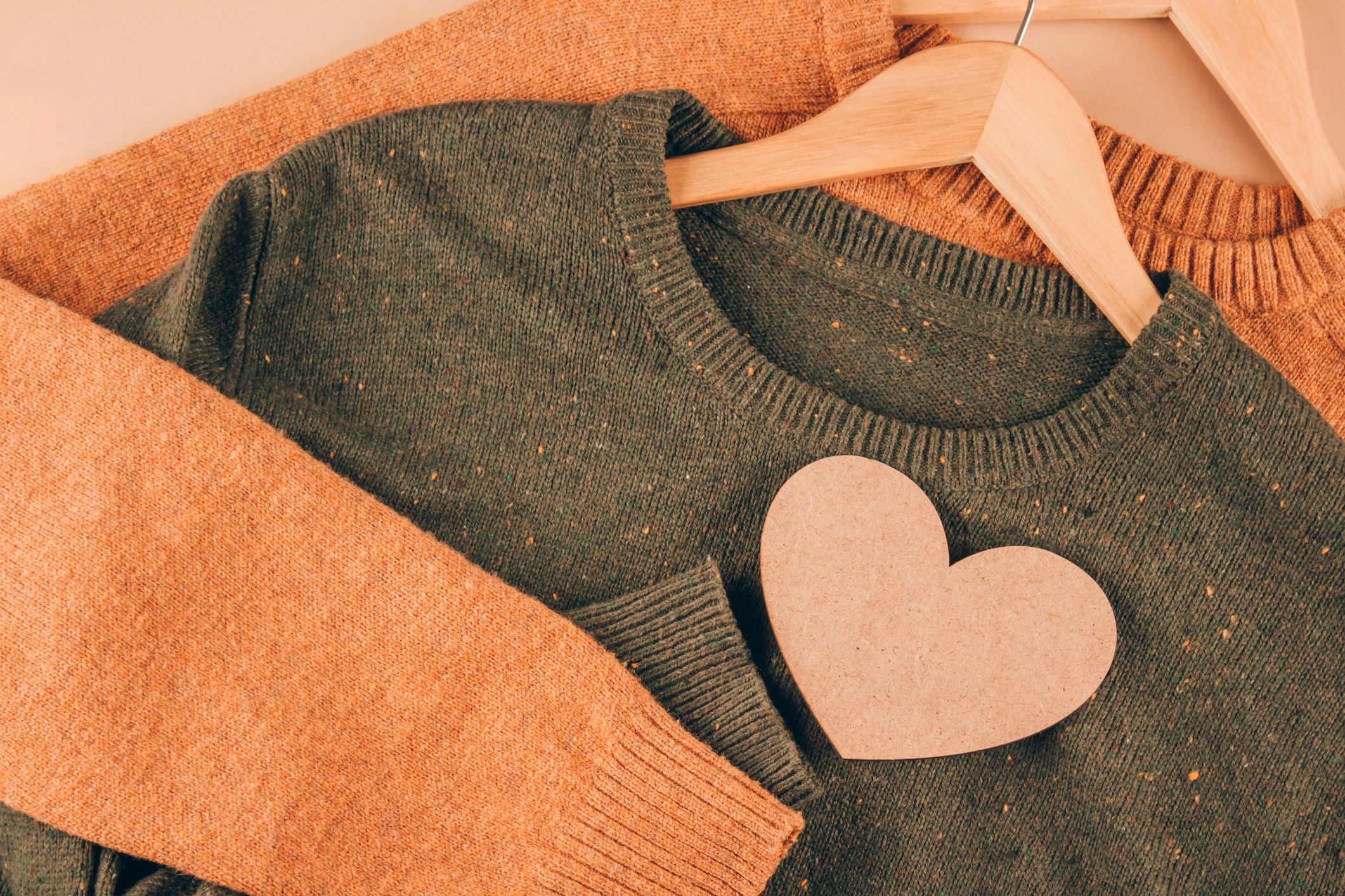 Sweaters on wooden hangers, slow fashion concept